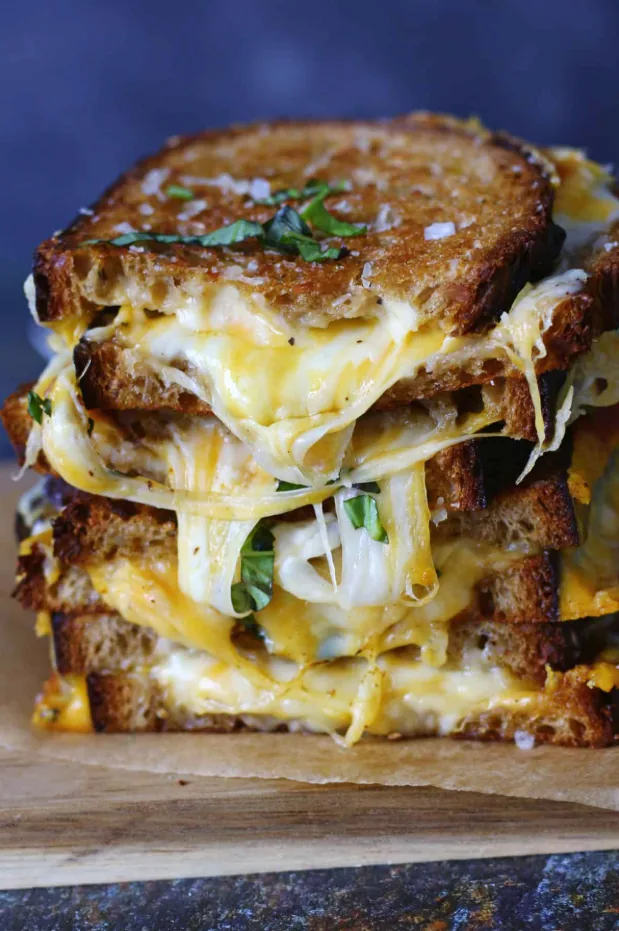 Stacked grilled cheese sandwich, golden crust, melted cheese cross-section